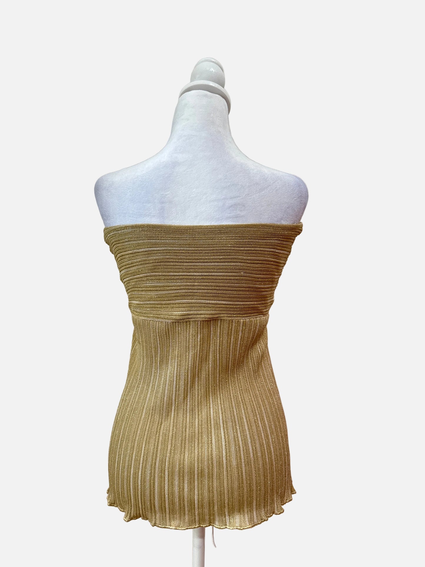Gold pleated dress on a mannequin against a white background