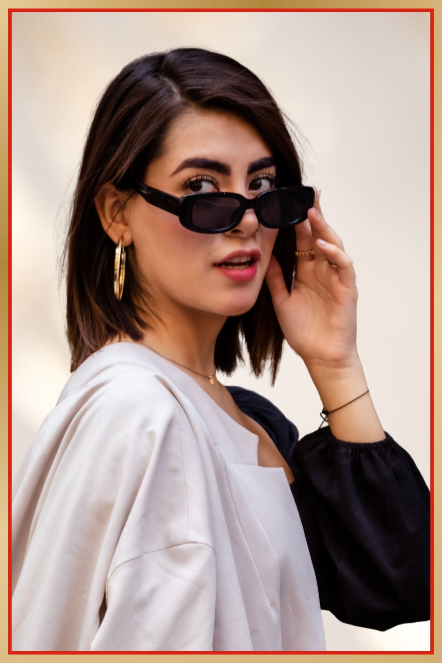 Woman wearing black sunglasses with a blurred background