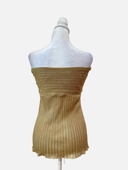 Gold pleated dress on a mannequin against a white background
